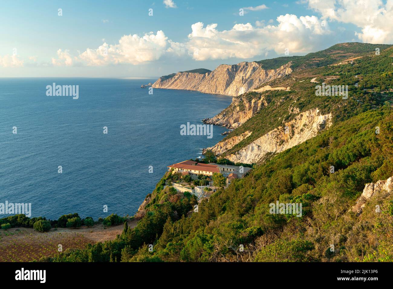 High angle view of Kipoureon monastery surrounded by trees on top of rocks overhanging the sea, Kefalonia, Ionian Islands, Greek Islands, Greece Stock Photo