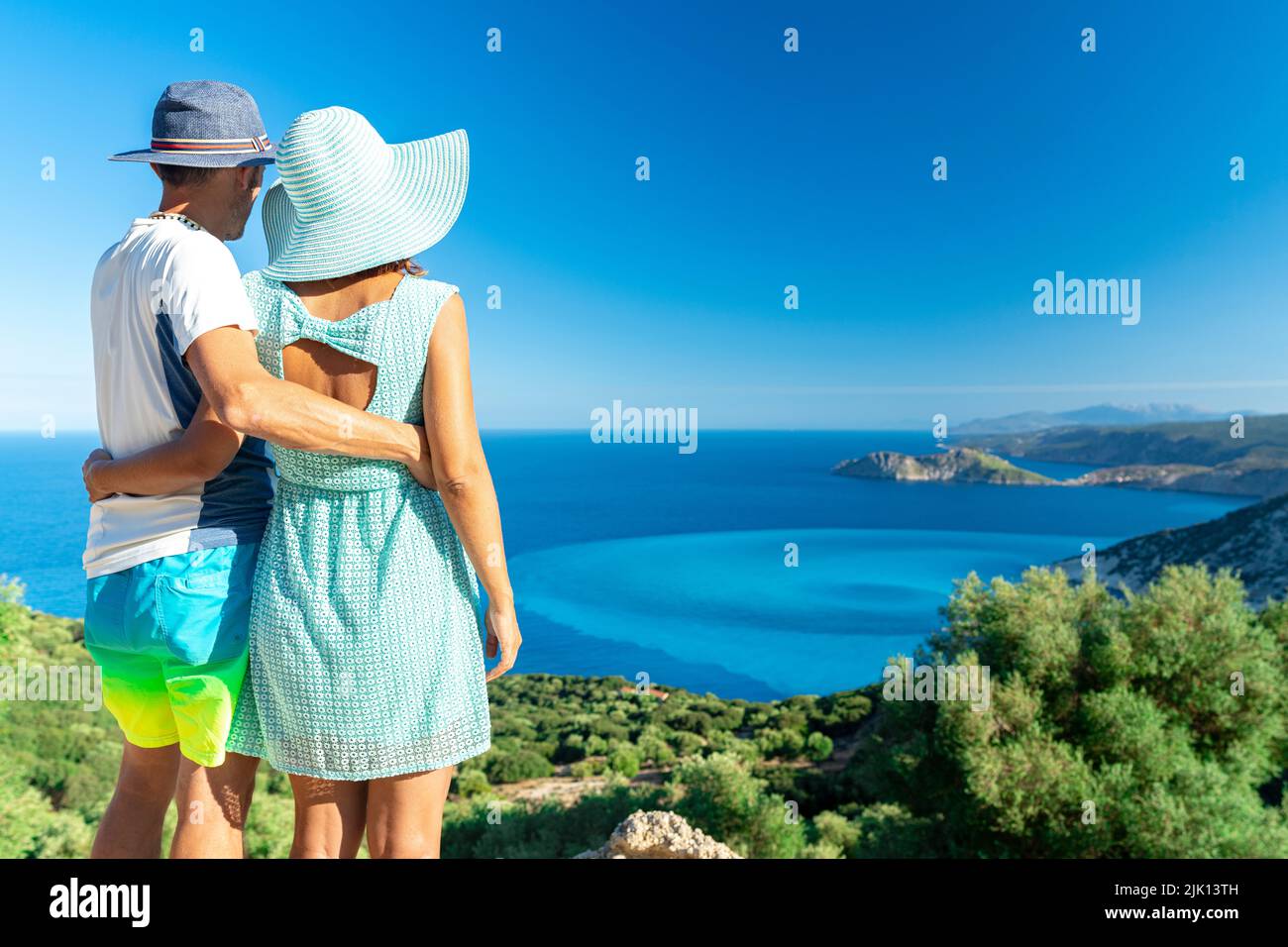 Man and woman in love embracing looking at the crystal sea, Myrtos beach, Kefalonia, Ionian Islands, Greek Islands, Greece, Europe Stock Photo