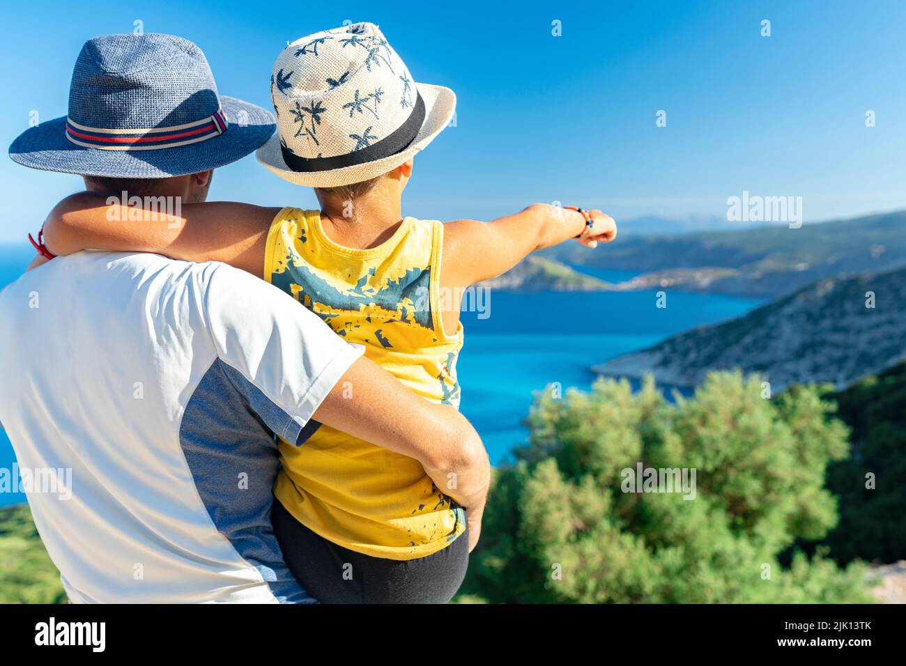 Happy father with cute little boy admiring the sea surrounding Myrtos beach from coastline, Kefalonia, Ionian Islands, Greek Islands, Greece, Europe Stock Photo