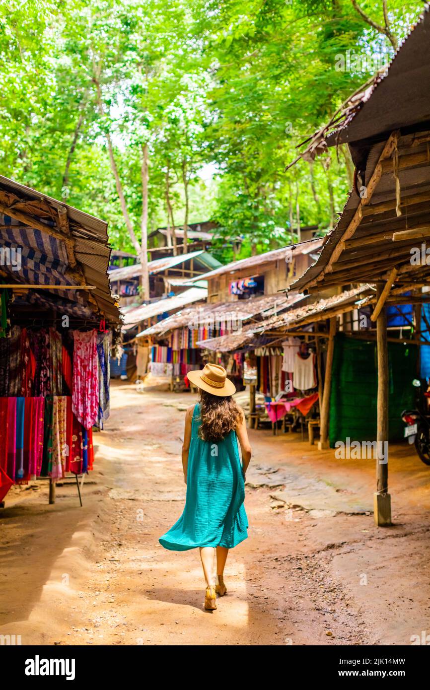Woman walking in village street, Thailand, Southeast Asia, Asia Stock Photo