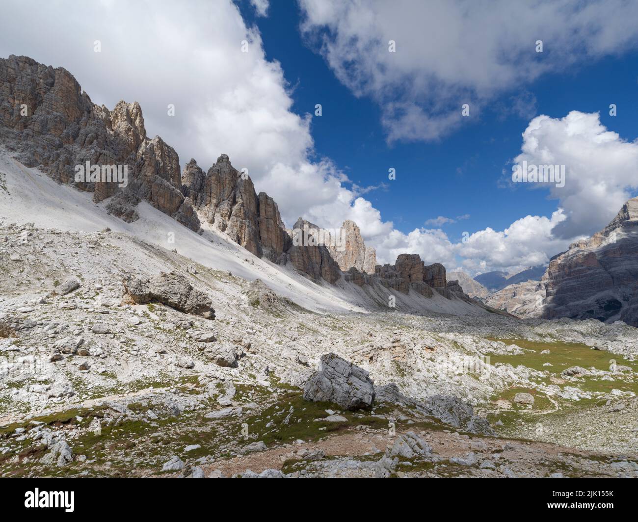 White clouds blue sky over rocks in the dolomites hi-res stock ...