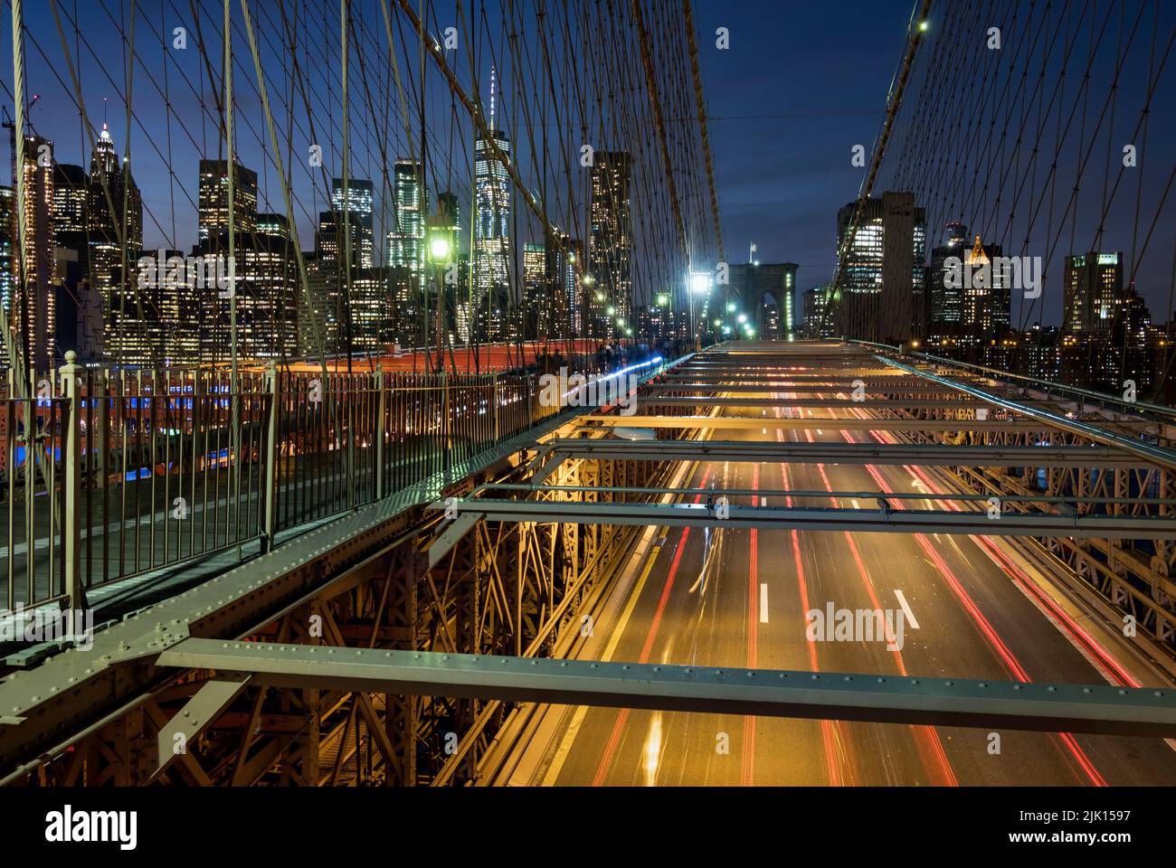 Traffic crossing the Brooklyn Bridge with the Manhattan skyline beyond at night, Manhattan, New York, United States of America, North America Stock Photo