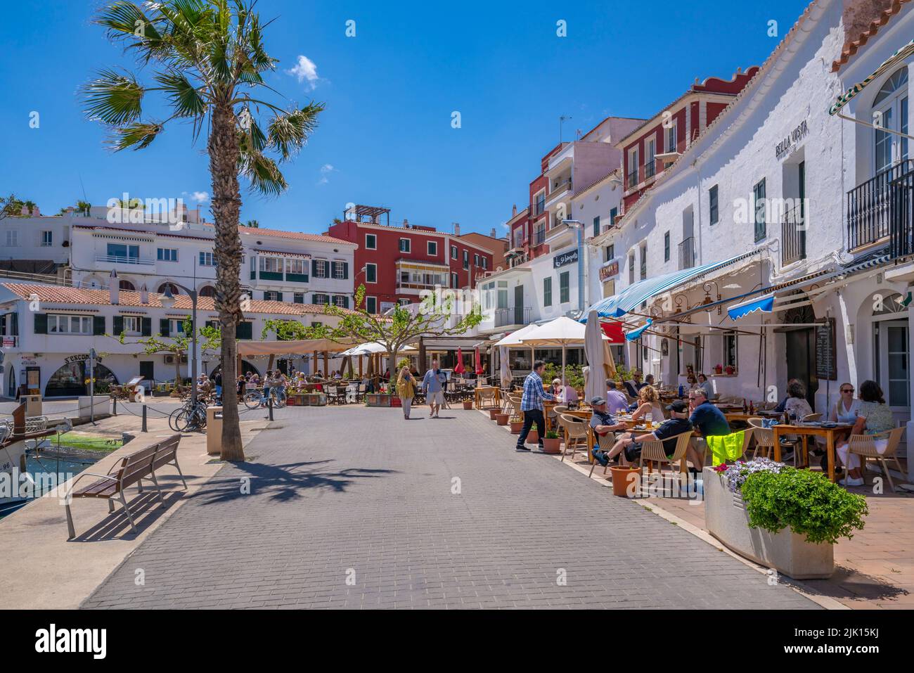 View of colourful cafes, restaurants in harbour against blue sky, Cales Fonts, Menorca, Balearic Islands, Spain, Mediterranean, Europe Stock Photo