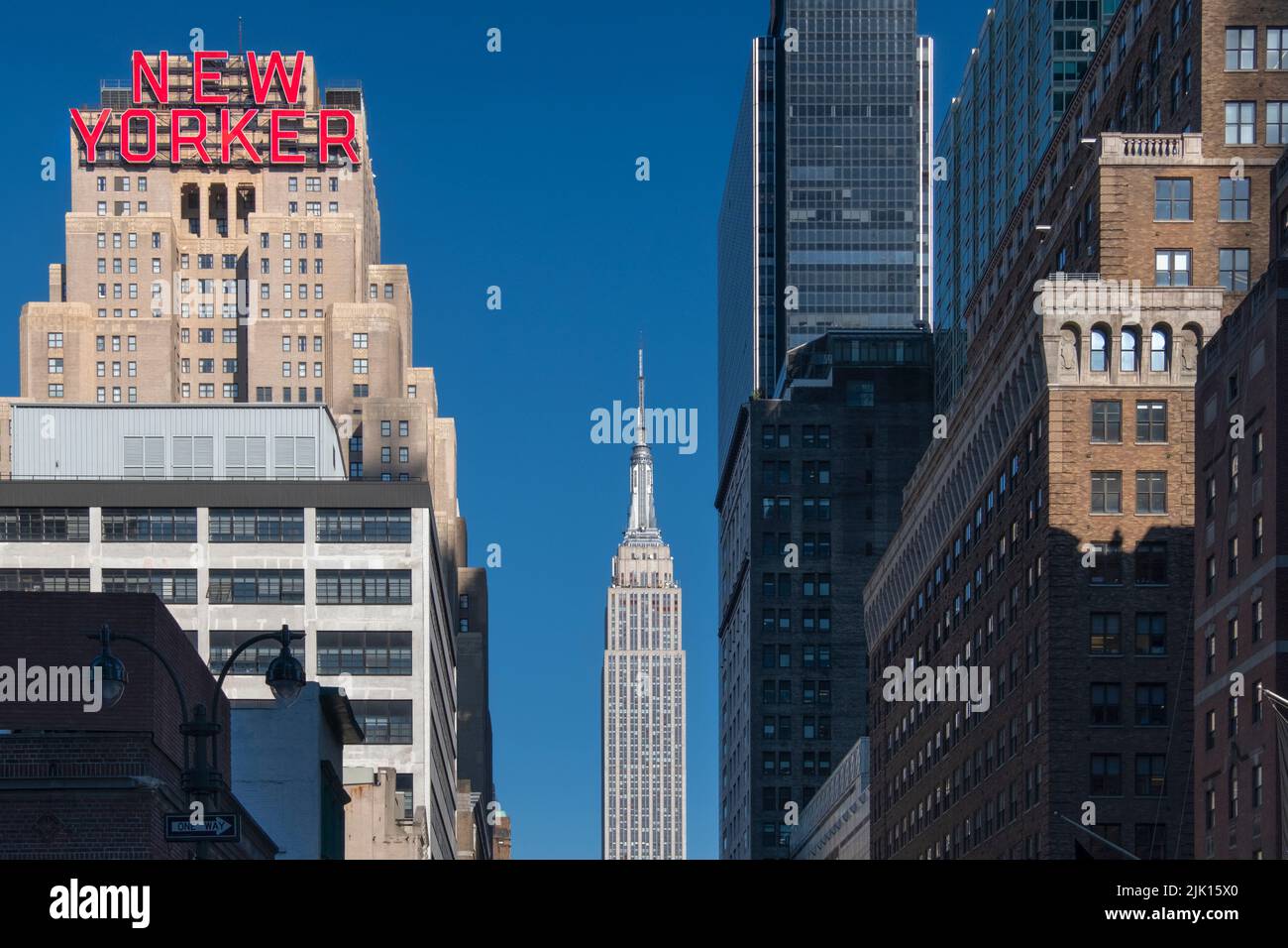 The New Yorker Hotel and Empire State Building viewed along 34th Street, Garment District, Manhattan, New York, United States of America Stock Photo
