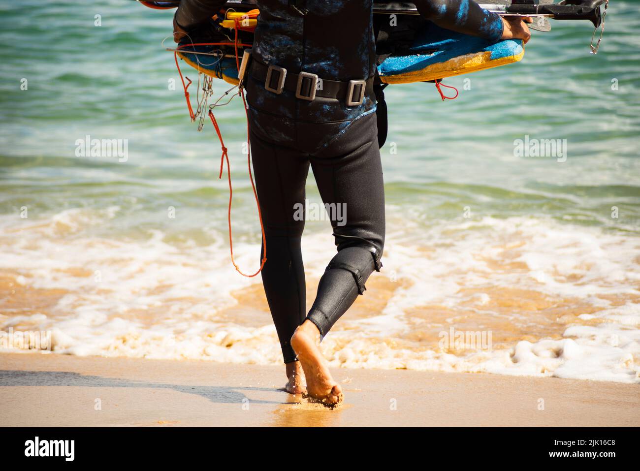 Man entering the sea with diving equipment. Porto da Barra beach, in Salvador, state of Bahia, Brazil. Stock Photo