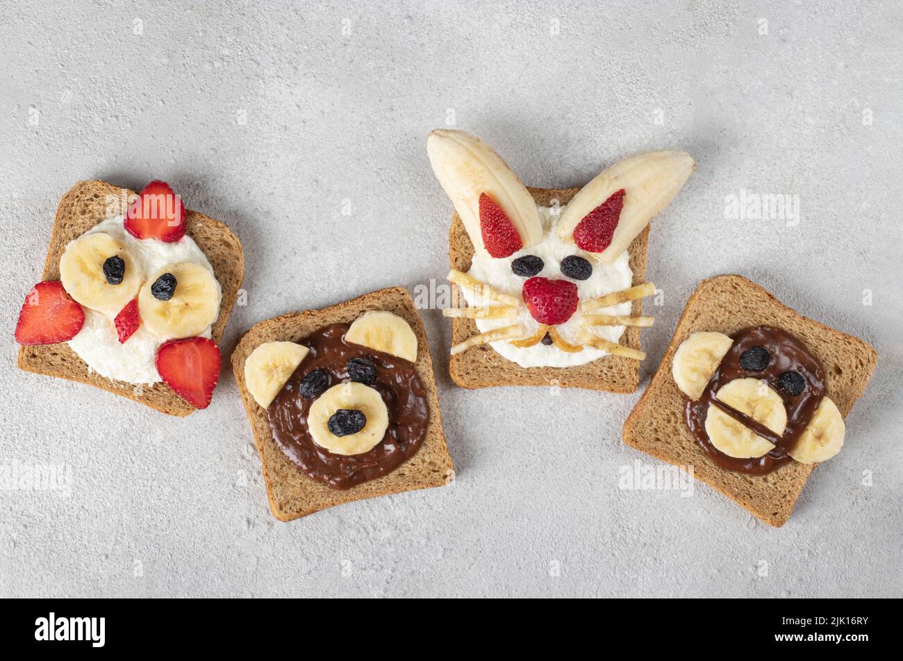 Four sweet toasts for kids in shape of chick, bear, rabbit and monkey ...
