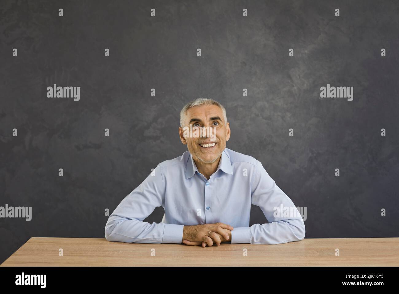 Smiling man look up at empty copy space Stock Photo