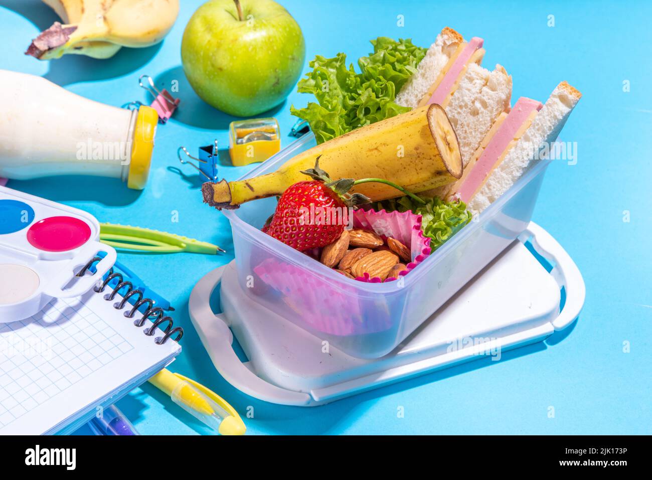 Healthy school lunch box sandwich, vegetables, fruit, nuts and yogurt