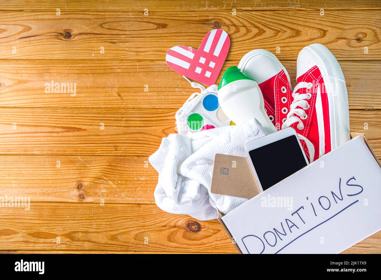 Donation Box with various give goods for Giving Tuesday, with red heart logo. Charity. Collect