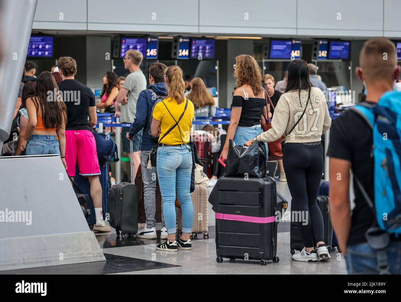 Duesseldorf, North Rhine-Westphalia, Germany - Duesseldorf airport, vacationers stand with suitcases at the check-in counter on the day of the warning Stock Photo