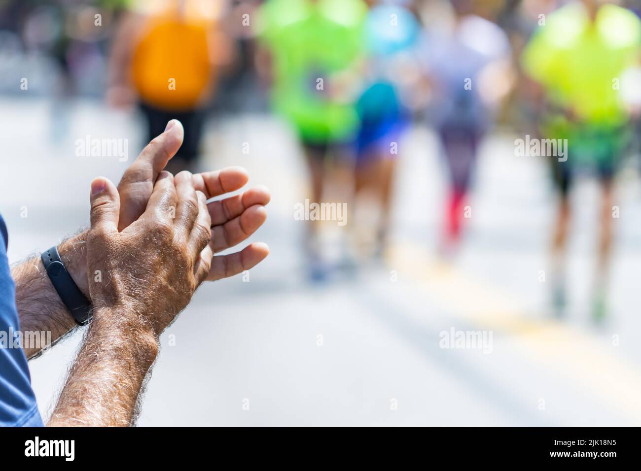 Applause from an unrecognizable man at a track and field marathon, sports concept. Stock Photo