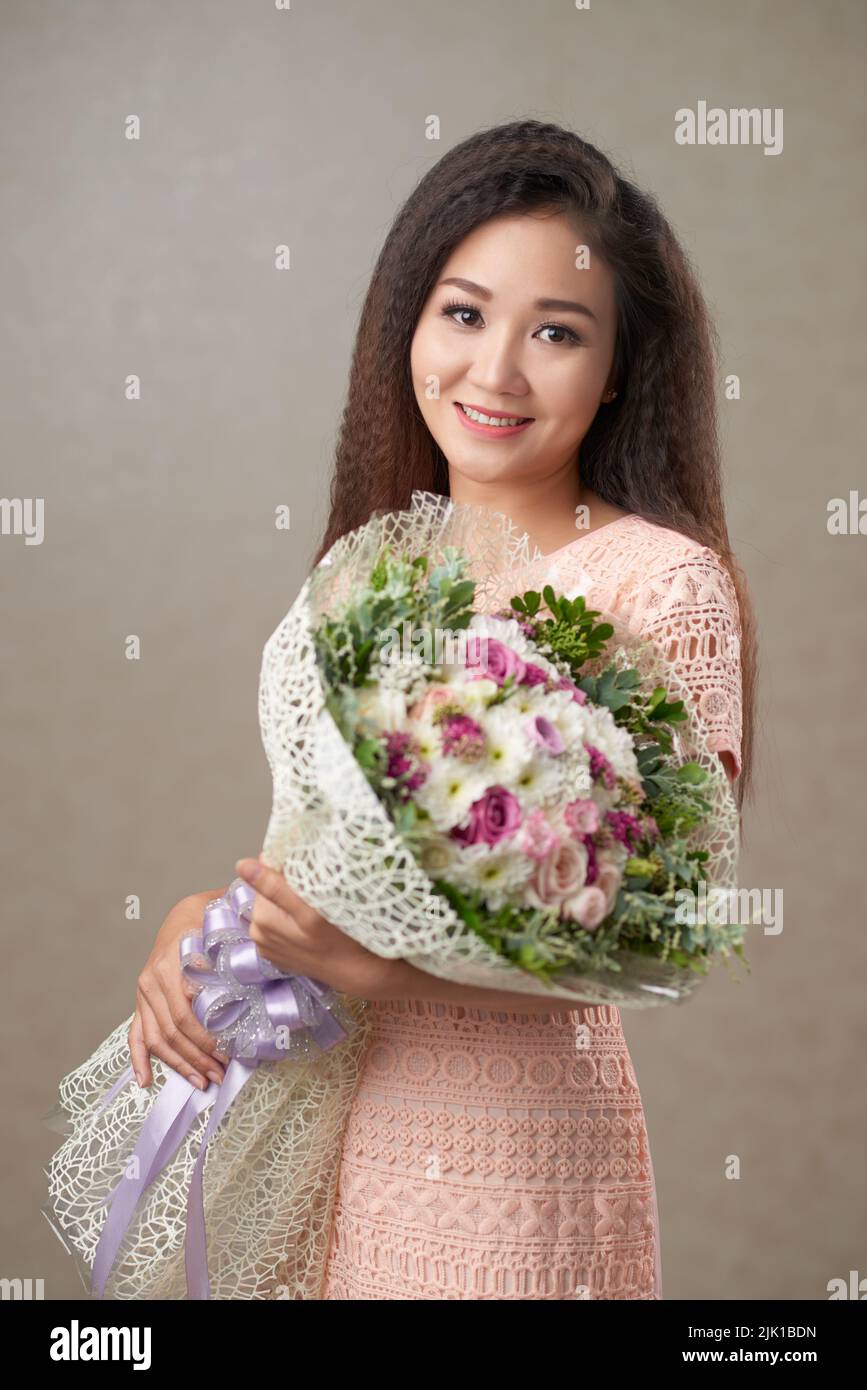 Portrait of Happy Vietnamese young woman with a big bouquet Stock Photo
