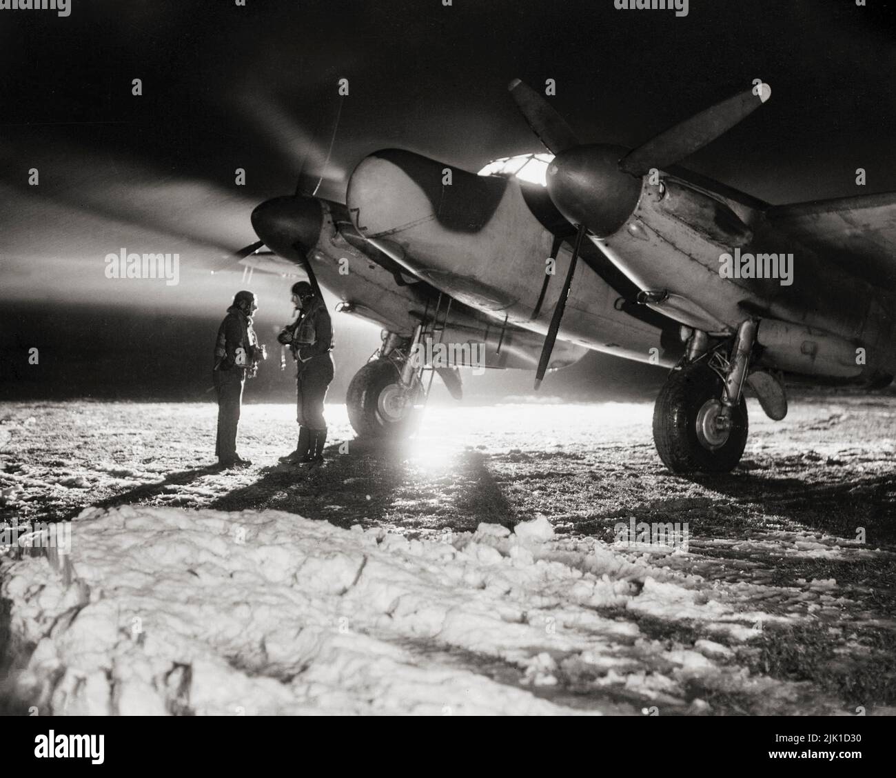 A De Havilland Mosquito NF Mark XII of 604 Squadron RAF, in the snow at B51/Lille-Vendeville, France, before taking off on a night-fighter sortie. The 'Wooden Wonder' or 'Mossie' was a British twin-engined, shoulder-winged, multirole combat aircraft, introduced during the Second World War. Unusual in that its frame was constructed mostly of wood. Stock Photo