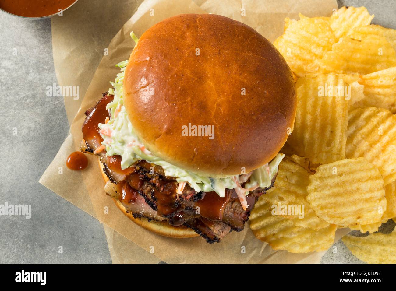 Homemade Chopped Brisket Sandwich with BBQ Sauce and Chips Stock Photo