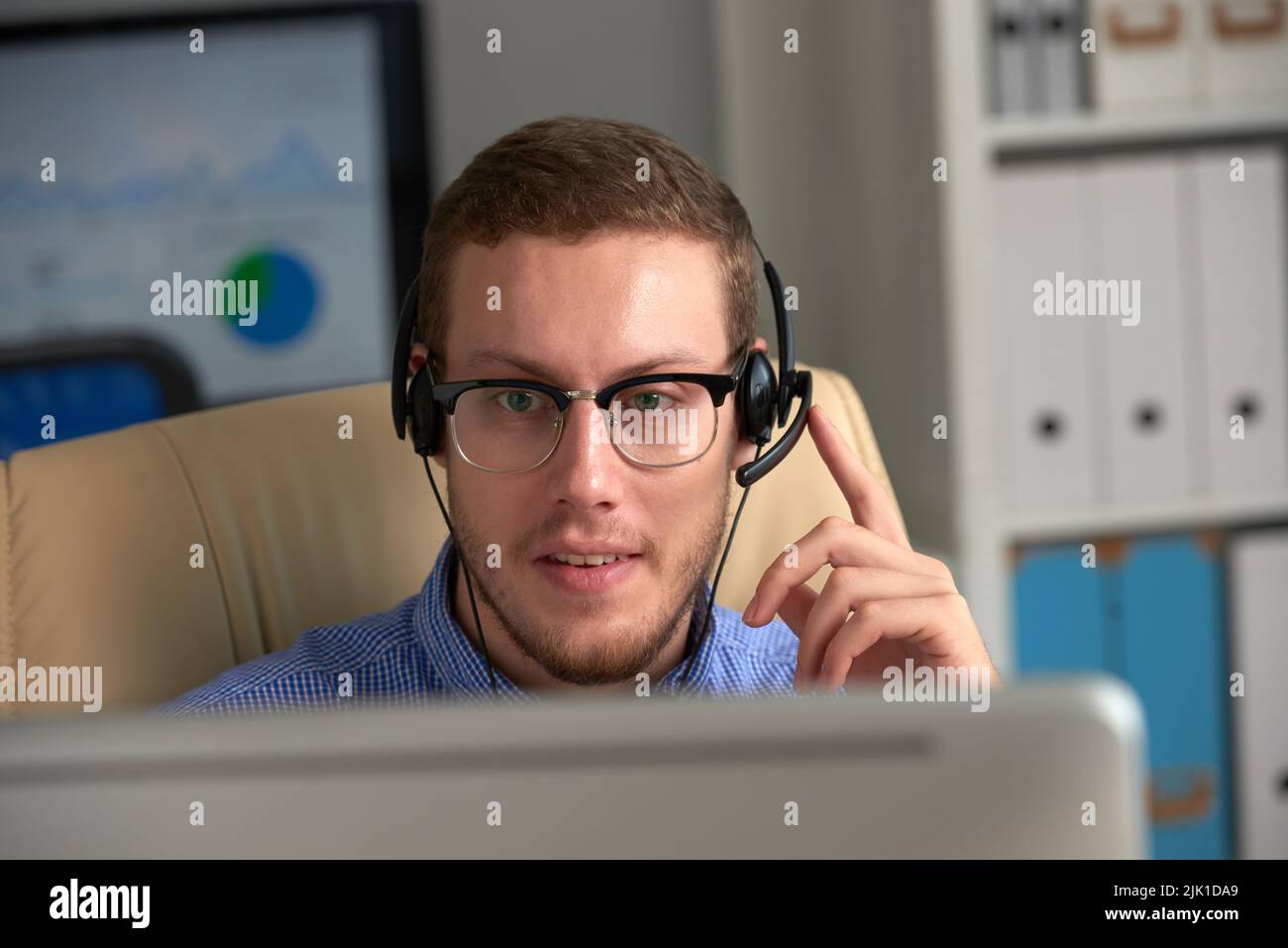 Smiling call center operator consulting client on the phone Stock Photo ...