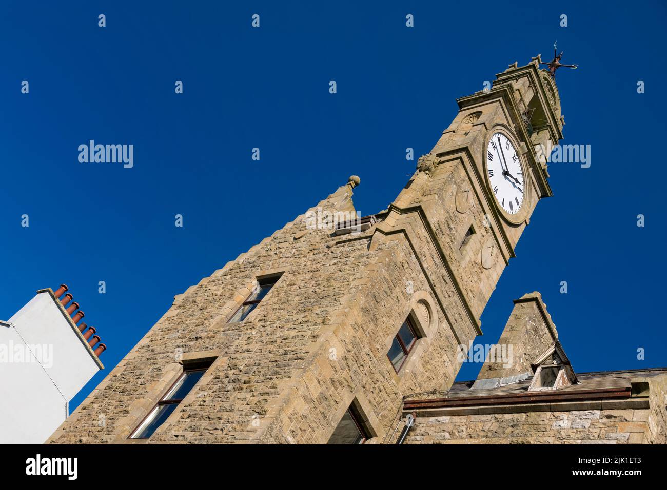 Ireland, County Donegal, Ballyshannon, The Town Clock, Perched at the top of a Scottish style baronial building built in 1878, the tall two-storey clock and bell tower with crow-stepped gables was built for the Belfast Bank who had commenced business in the town in 1869. Stock Photo