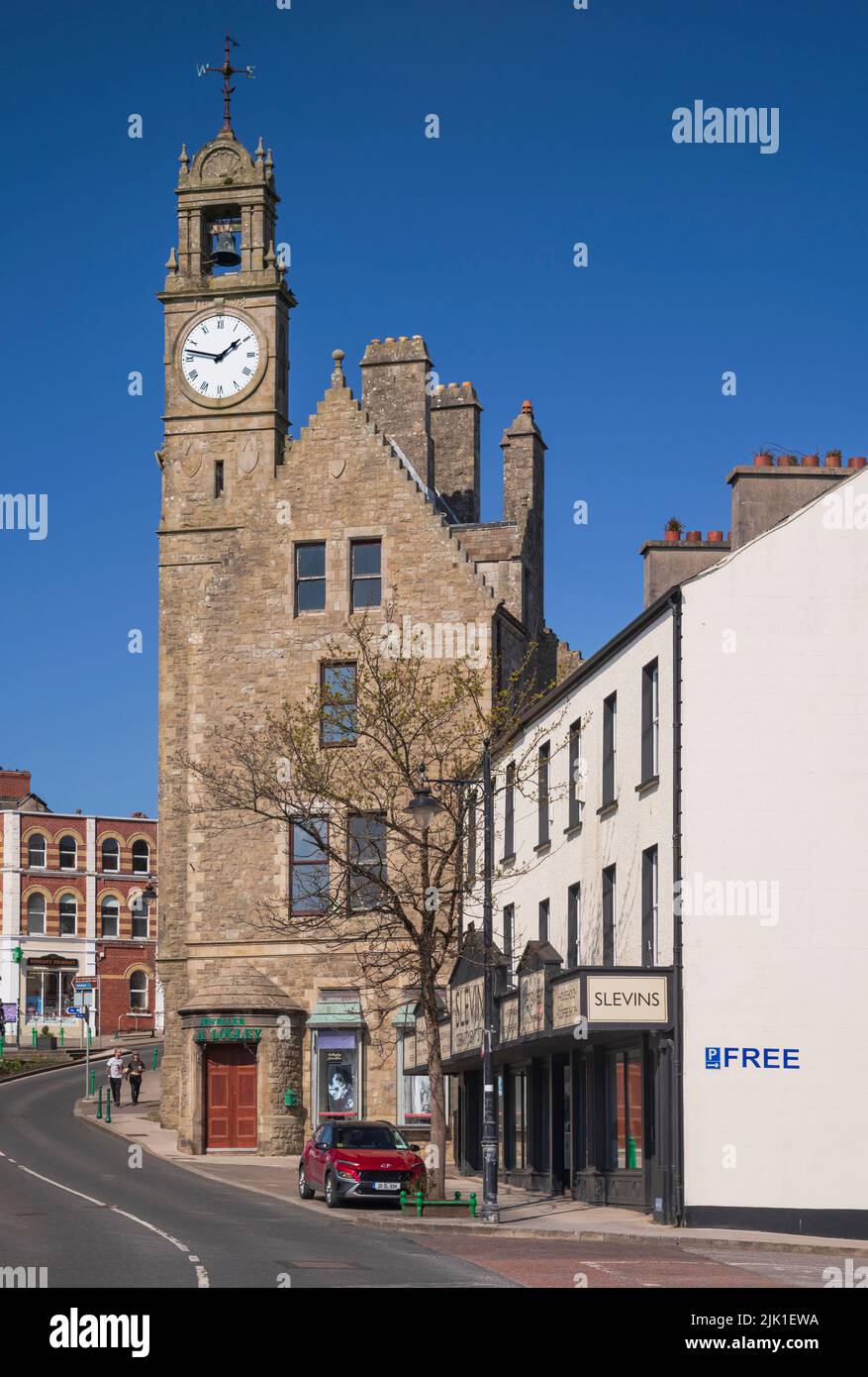 Ireland, County Donegal, Ballyshannon, The Town Clock, Perched at the top of a Scottish style baronial building built in 1878, the tall two-storey clock and bell tower with crow-stepped gables was built for the Belfast Bank who had commenced business in the town in 1869. Stock Photo
