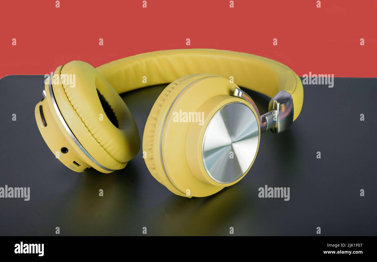 Yellow color wireless headphone closeup concept of music and exercise. Stock Photo