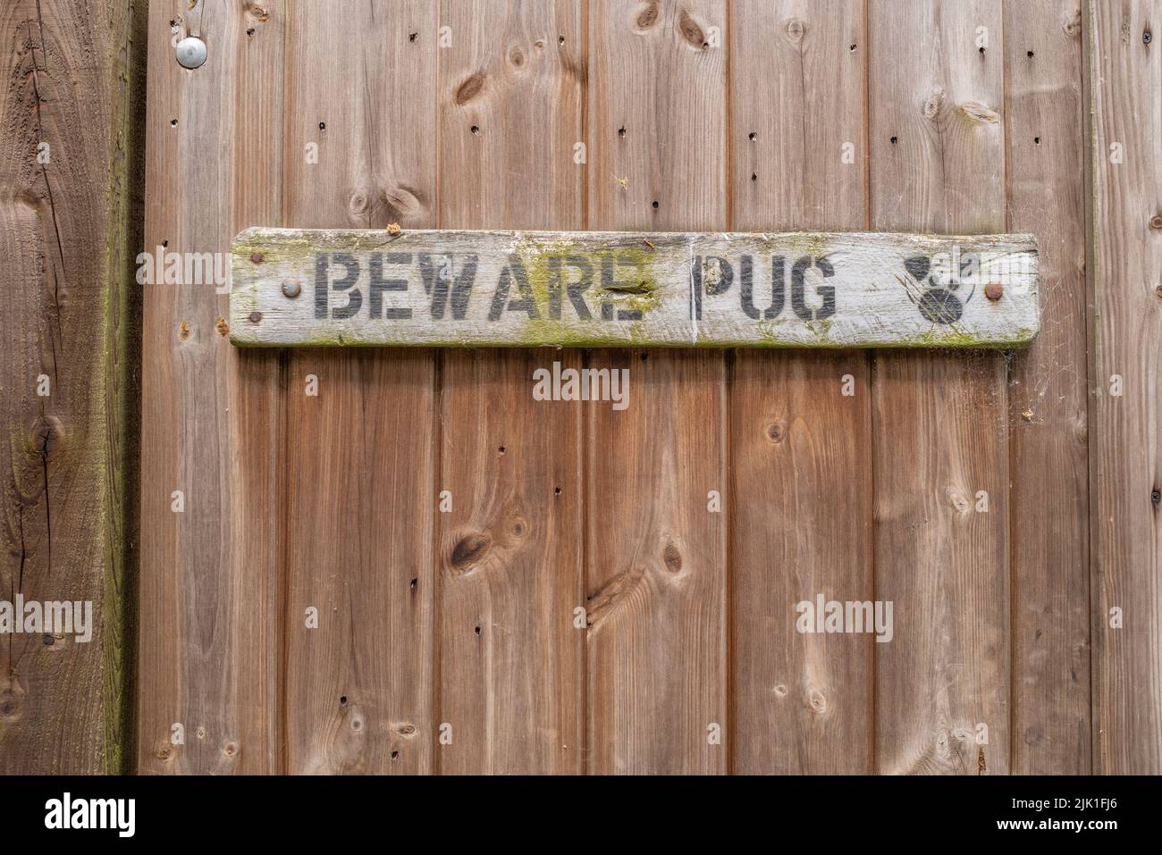 A house gate dispalying Beware Pug sign. Stock Photo