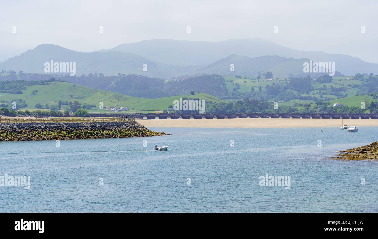 Beaches of fine sand and boats moored in the sea near the shore. Suances Santander. Stock Photo