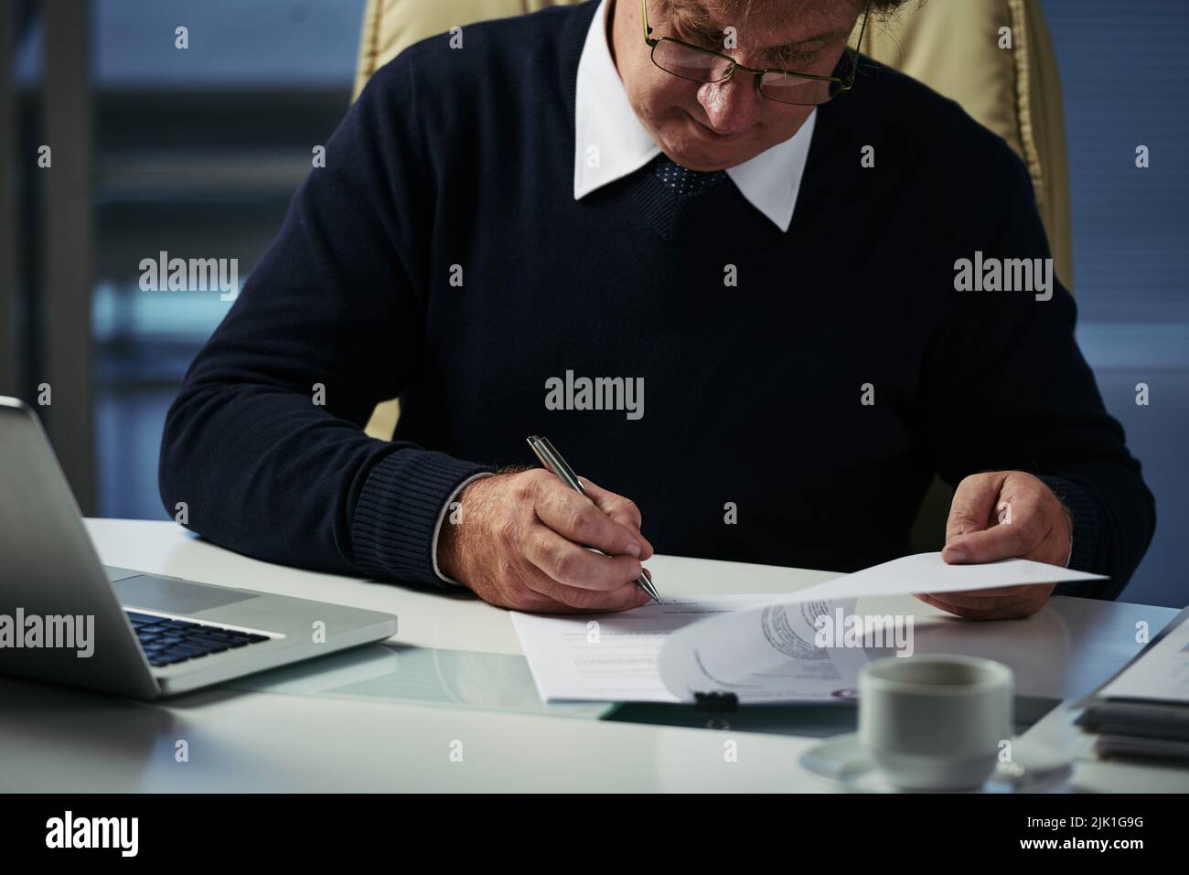 Businessman checking financial document on his table Stock Photo
