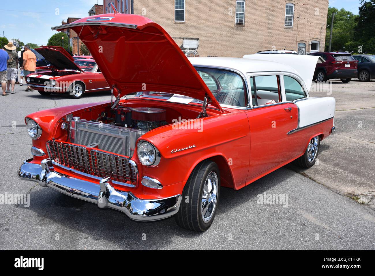 A Red and White 1955 Chevrolet on display at a car show. Stock Photo