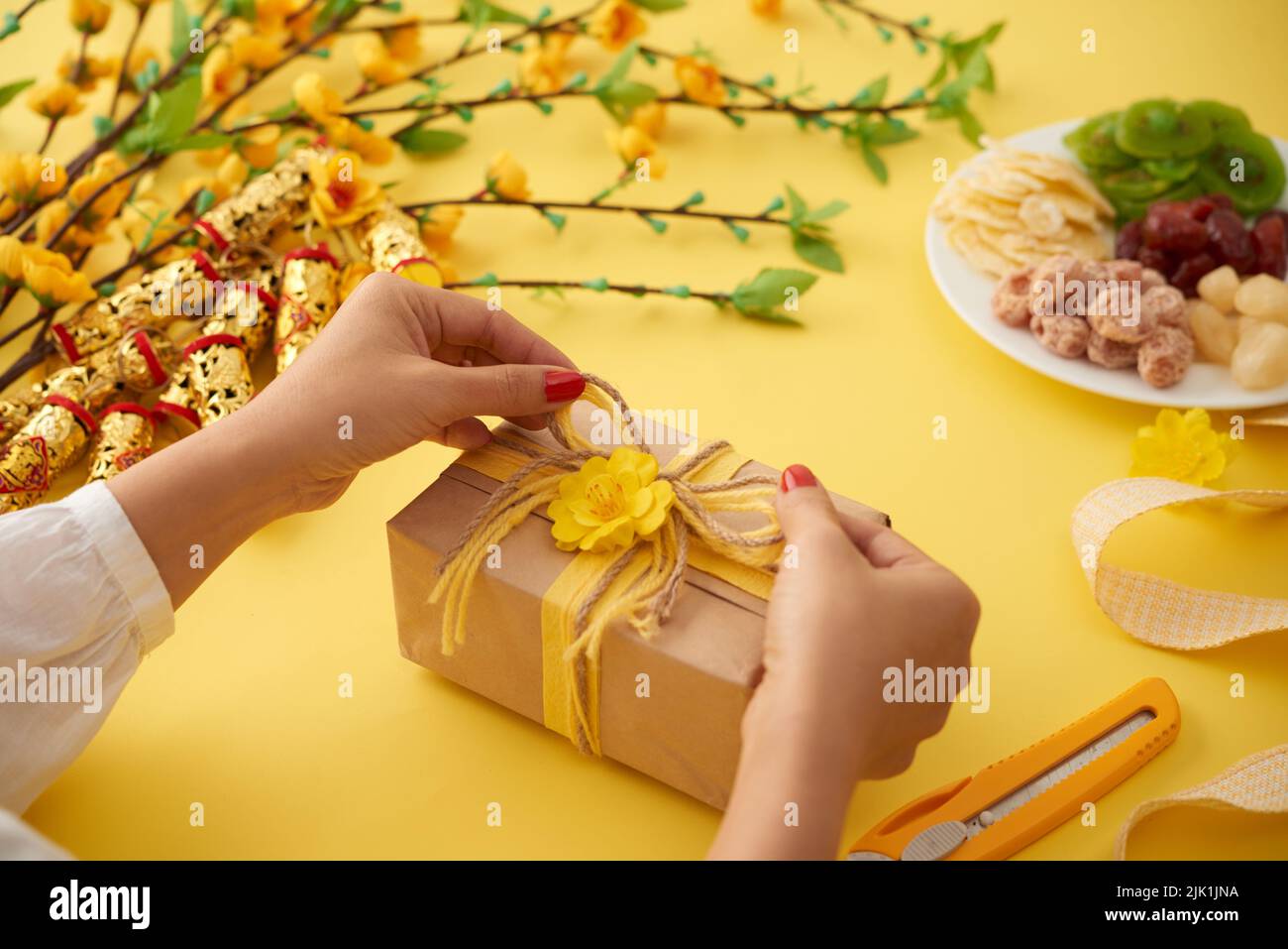 Hands of woman wrapping Chinese New Year present Stock Photo Alamy