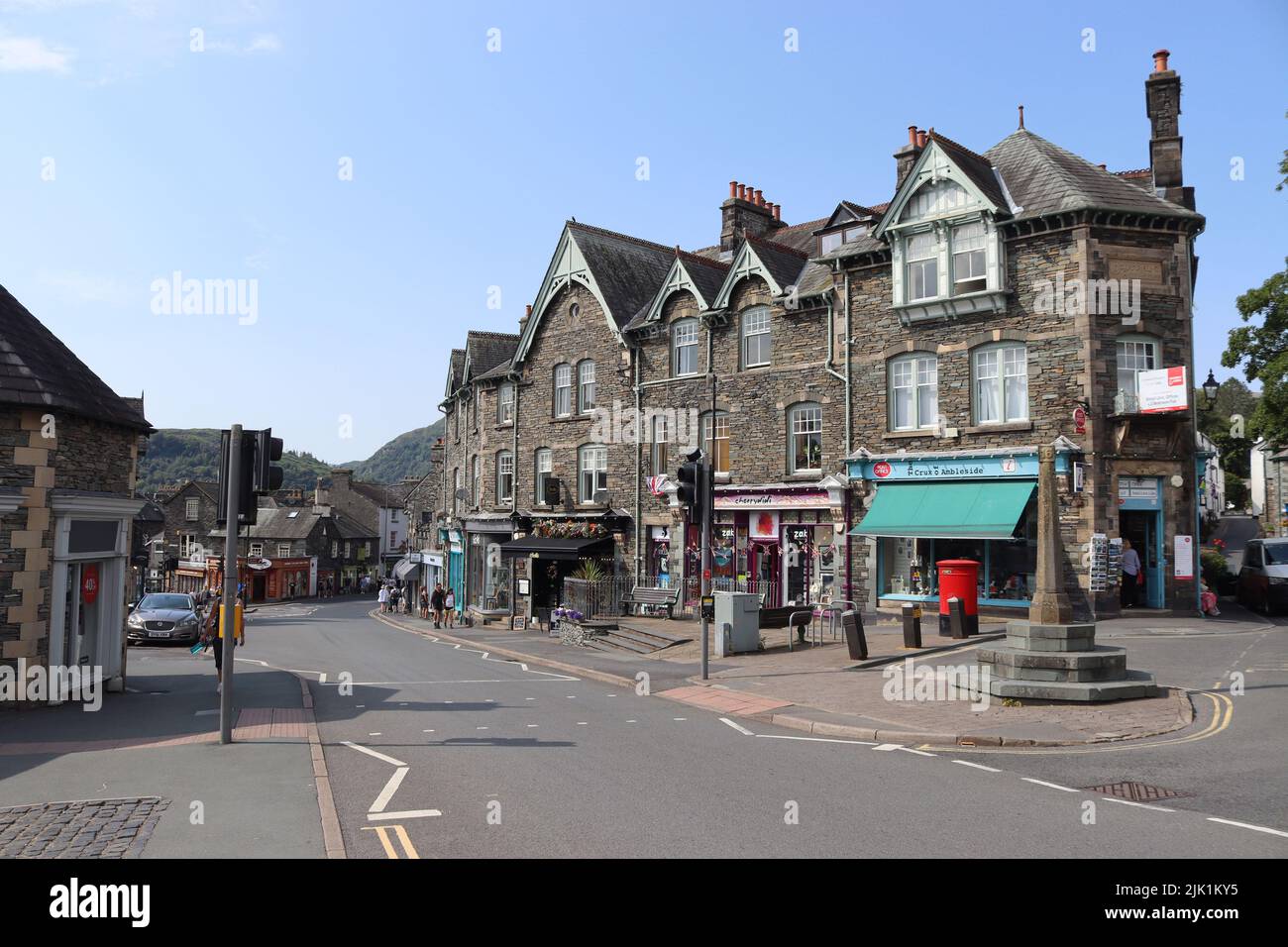 AMBLESIDE, ENGLAND, 18 JULY 2022: View of Ambleside Post office and town centre shops on Rydal Road (A591) in Cumbria on a sunny summers day. Amblesid Stock Photo