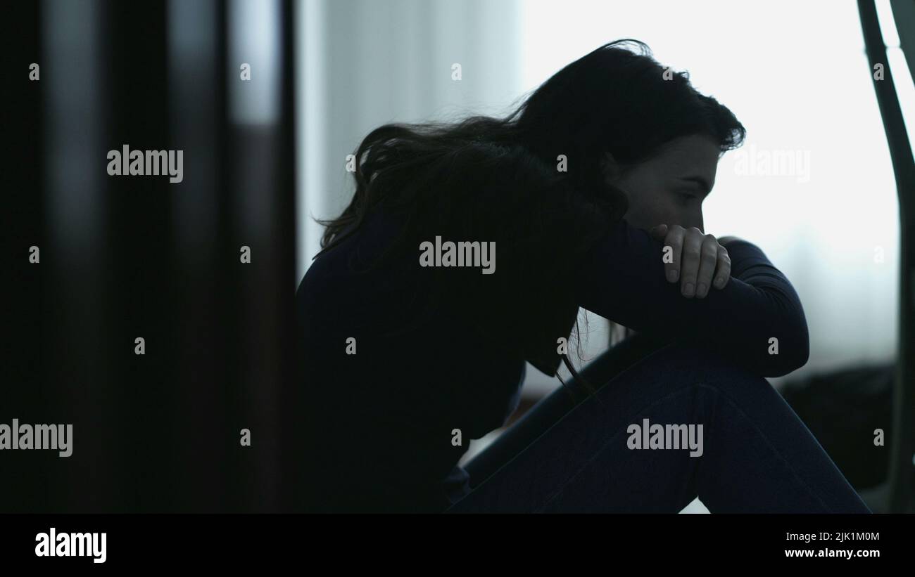 Hopeless person sitting on floor covering face suffering alone. Desperate  emotion during hard times. Girl feeling lonely Stock Photo - Alamy