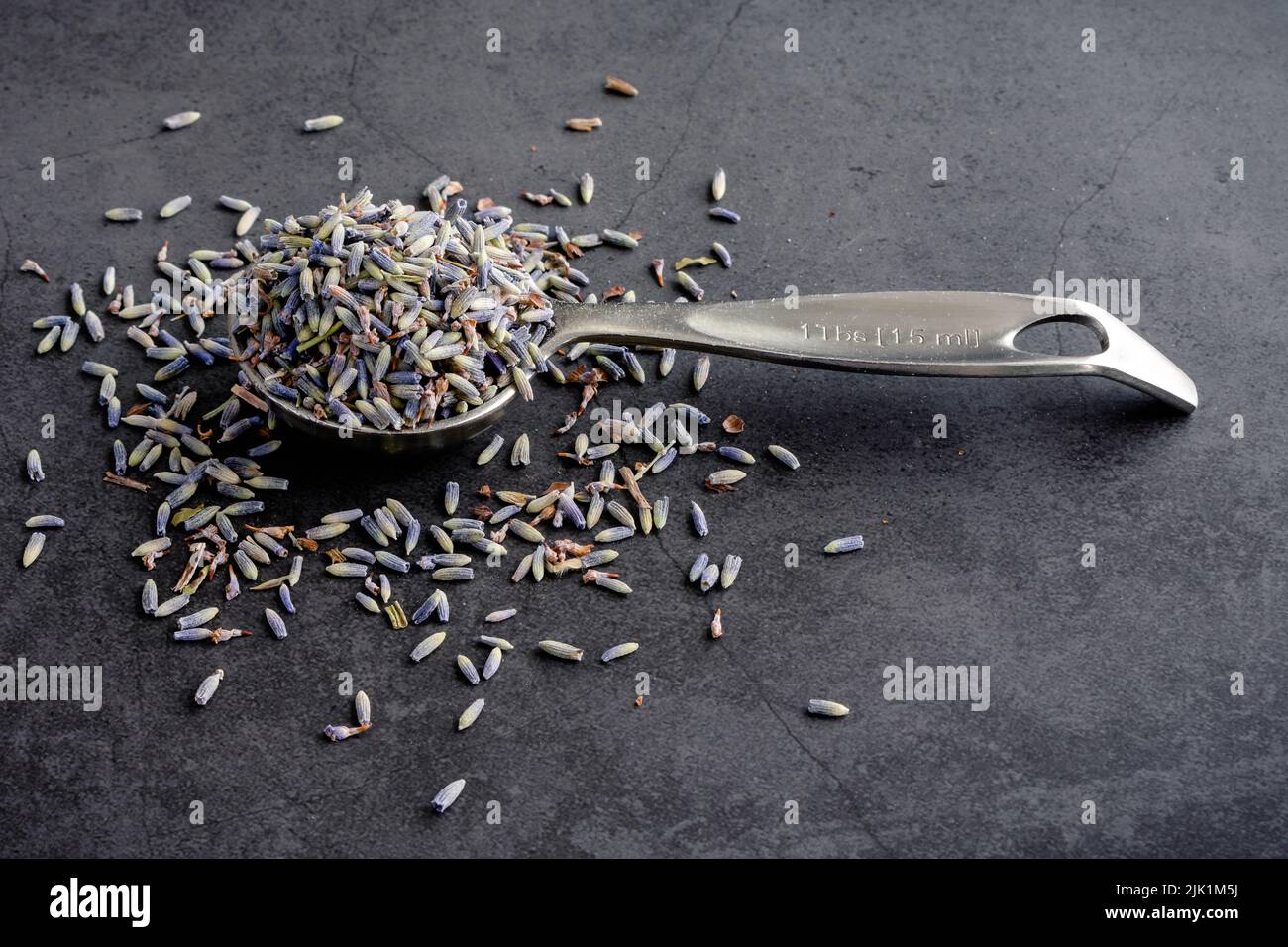 Dried Culinary Lavender Viewed from the Side A measuring spoon filled