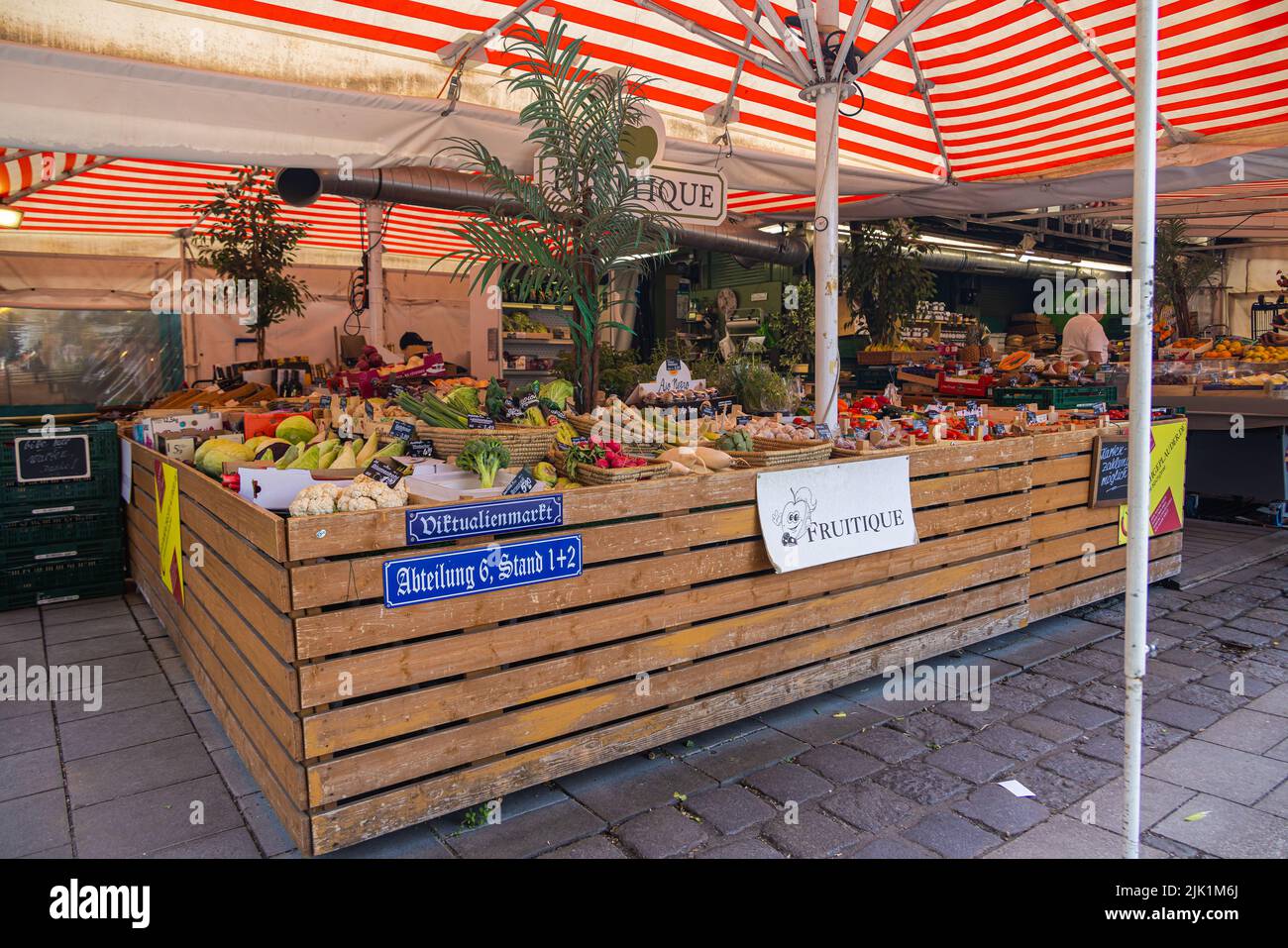 Munich, Germany - July 6, 2022: Vegetable stand at the Viktualienmarkt. The stall designation in form of street signs on the counter. Fresh market in Stock Photo