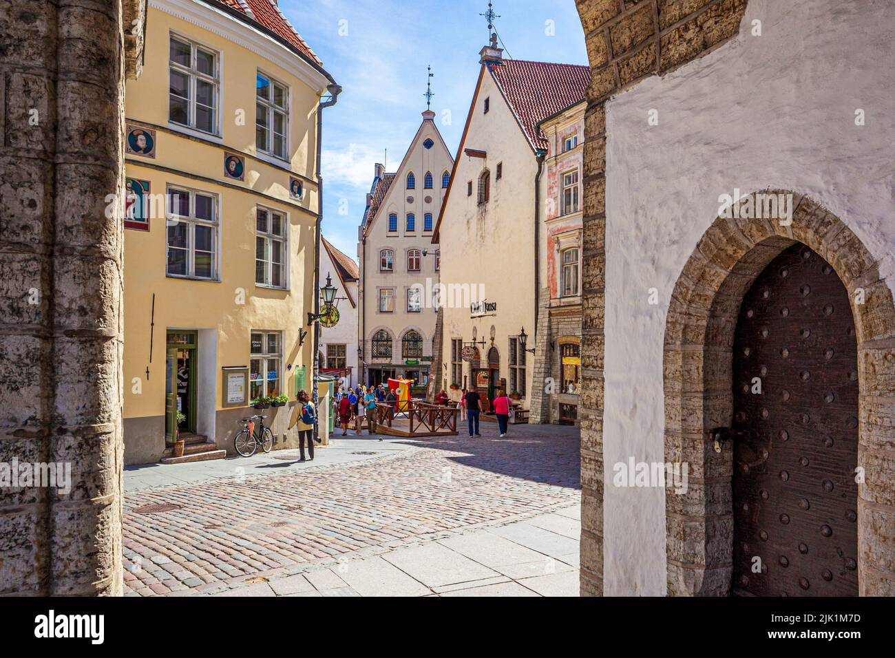 Looking out on the Old Town from the arches of the 14th century Town Hall (Tallinna raekoda) in the square of Tallinn the capital city of Estonia Stock Photo