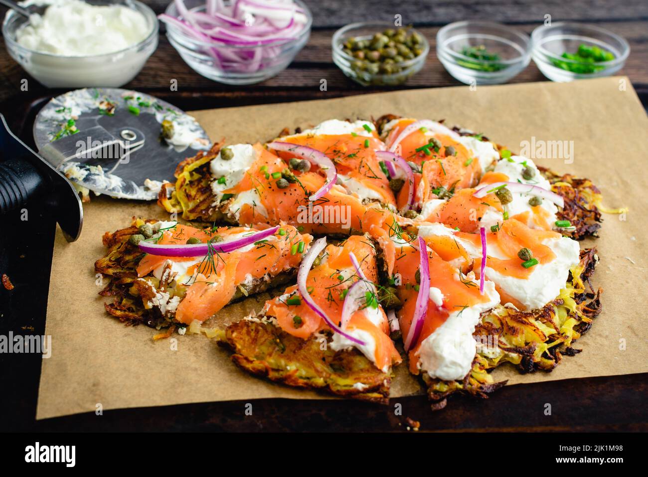 Sliced Potato Pancake Topped with Smoked Salmon and Labneh: Latkes topped with nova, capers, red onions, and fresh herbs Stock Photo