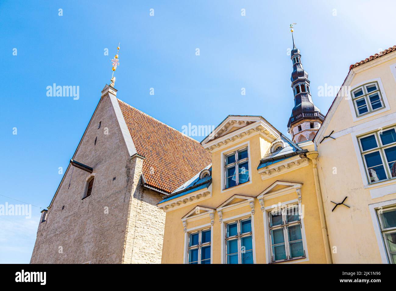 Rooflines including the Gothic tower and spire of the Town Hall (Tallinna raekoda) in the Old Town of Tallinn the capital city of Estonia Stock Photo