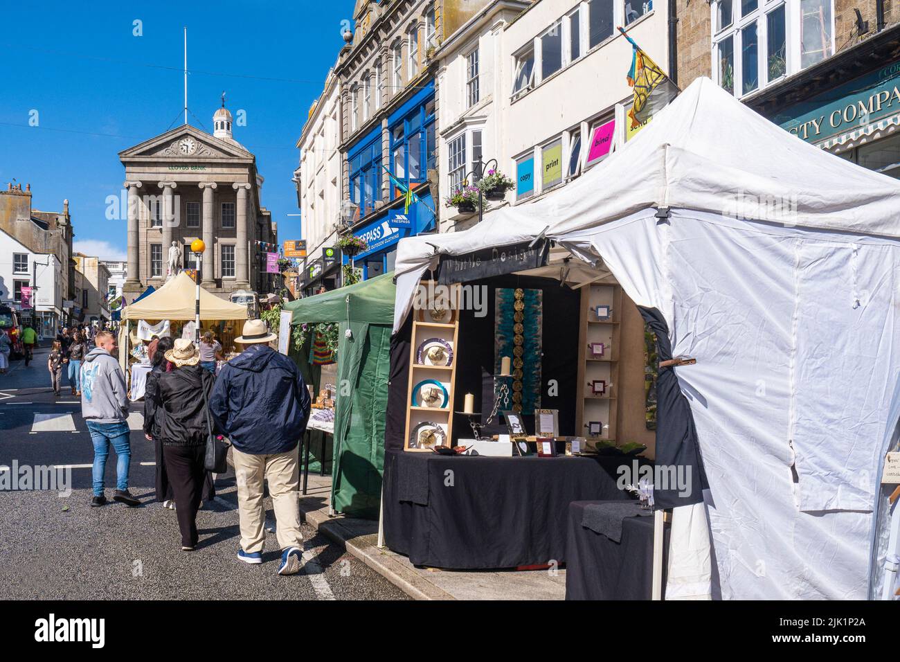 Stalls lining Market Jew Street in Penzance Town centre for Mazey Day part of the Golowan Festival in Cornwall in the UK. Stock Photo