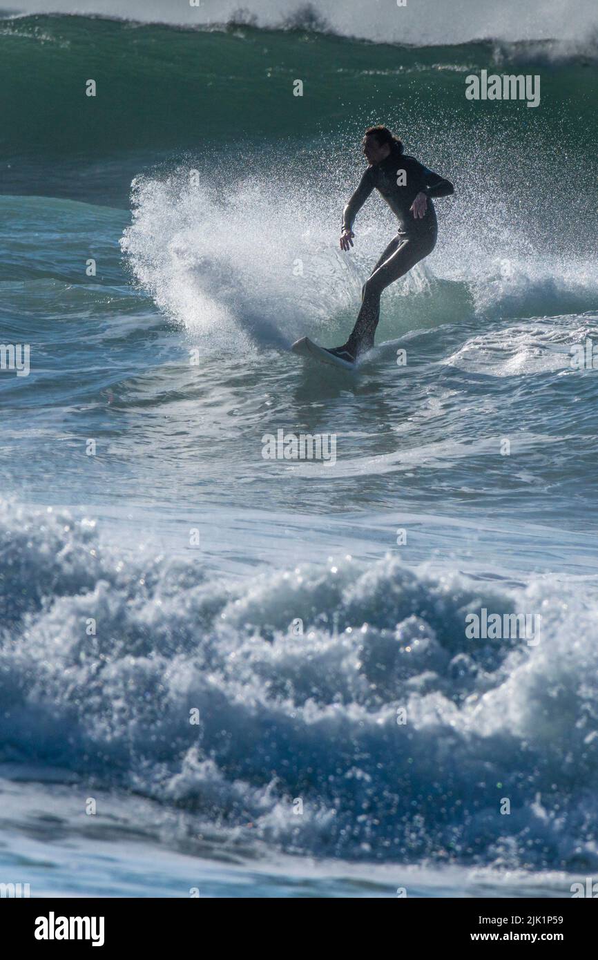 Surfing action and big waves at Fistral in Newquay in Cornwall in the UK. Stock Photo