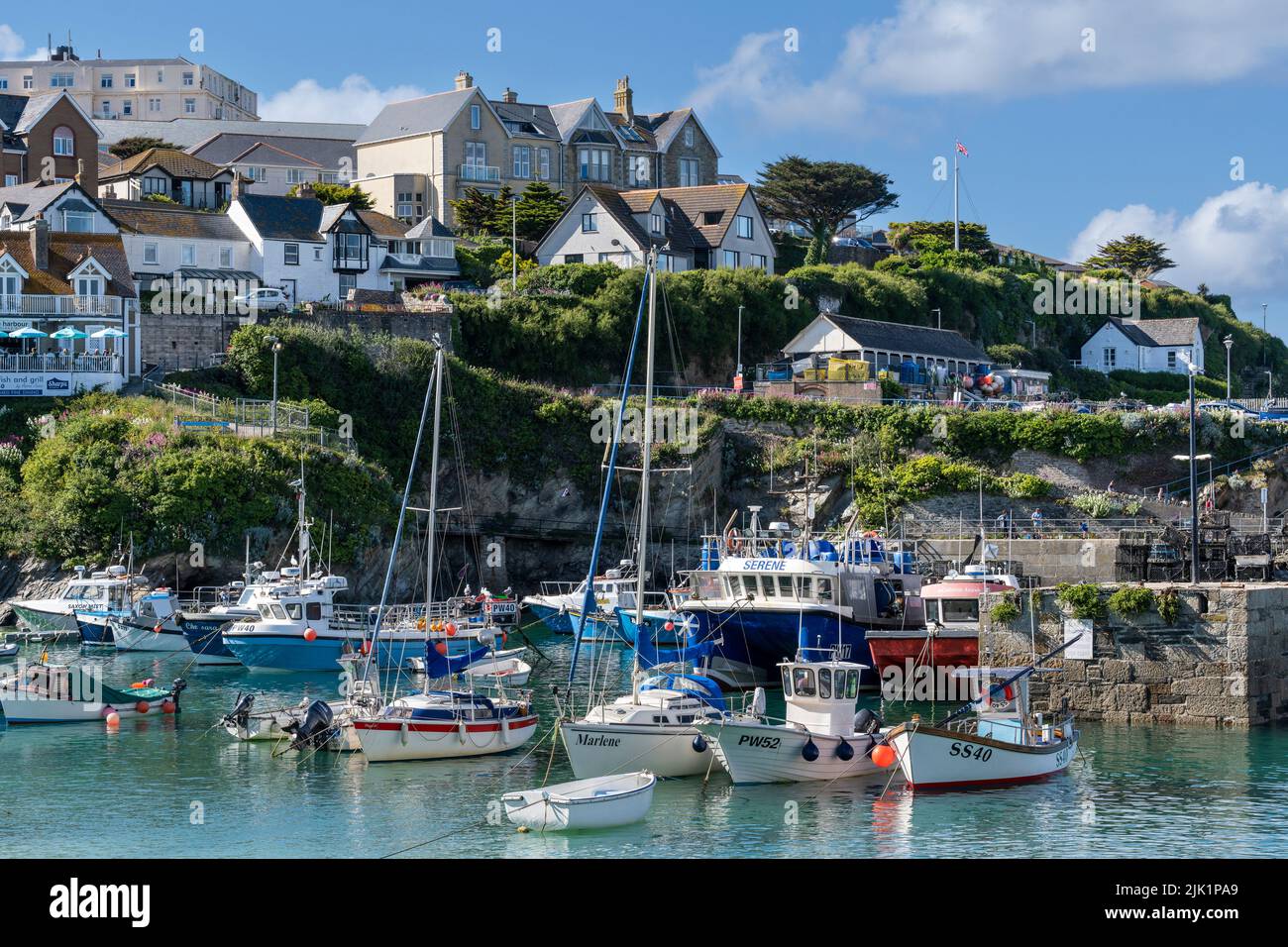 Various boats moored in the picturesque Newquay Harbour in Cornwall in the UK. Stock Photo