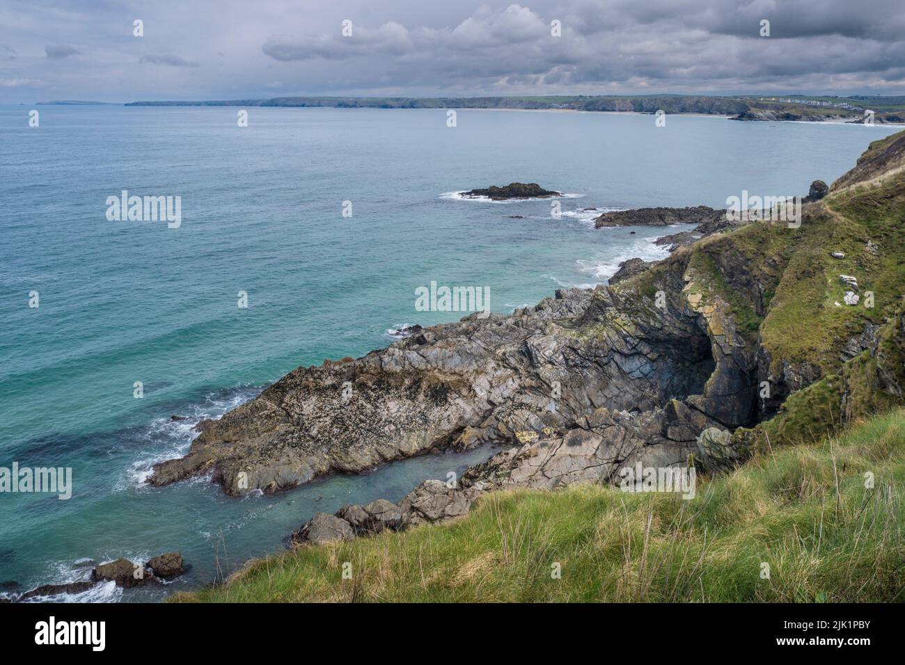 A view from the coast path over Newquay Bay in Newquay in Cornwall in the UK. Stock Photo