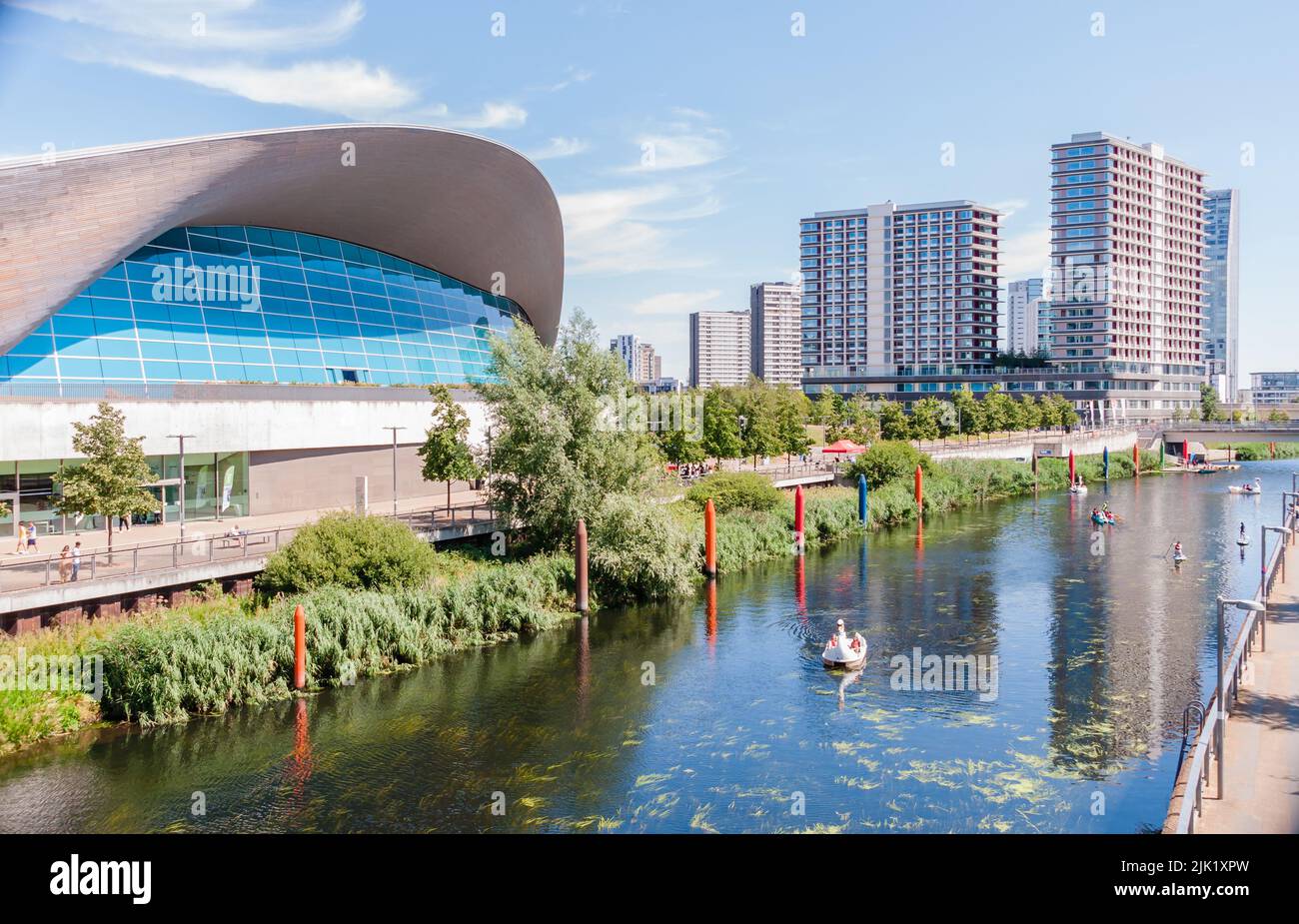 People enjoy the hot weather of floats on the Waterworks river that runs through the Olympic Park Stock Photo