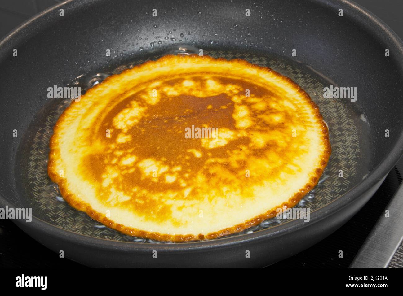 Prepare pancakes in a pan Stock Photo