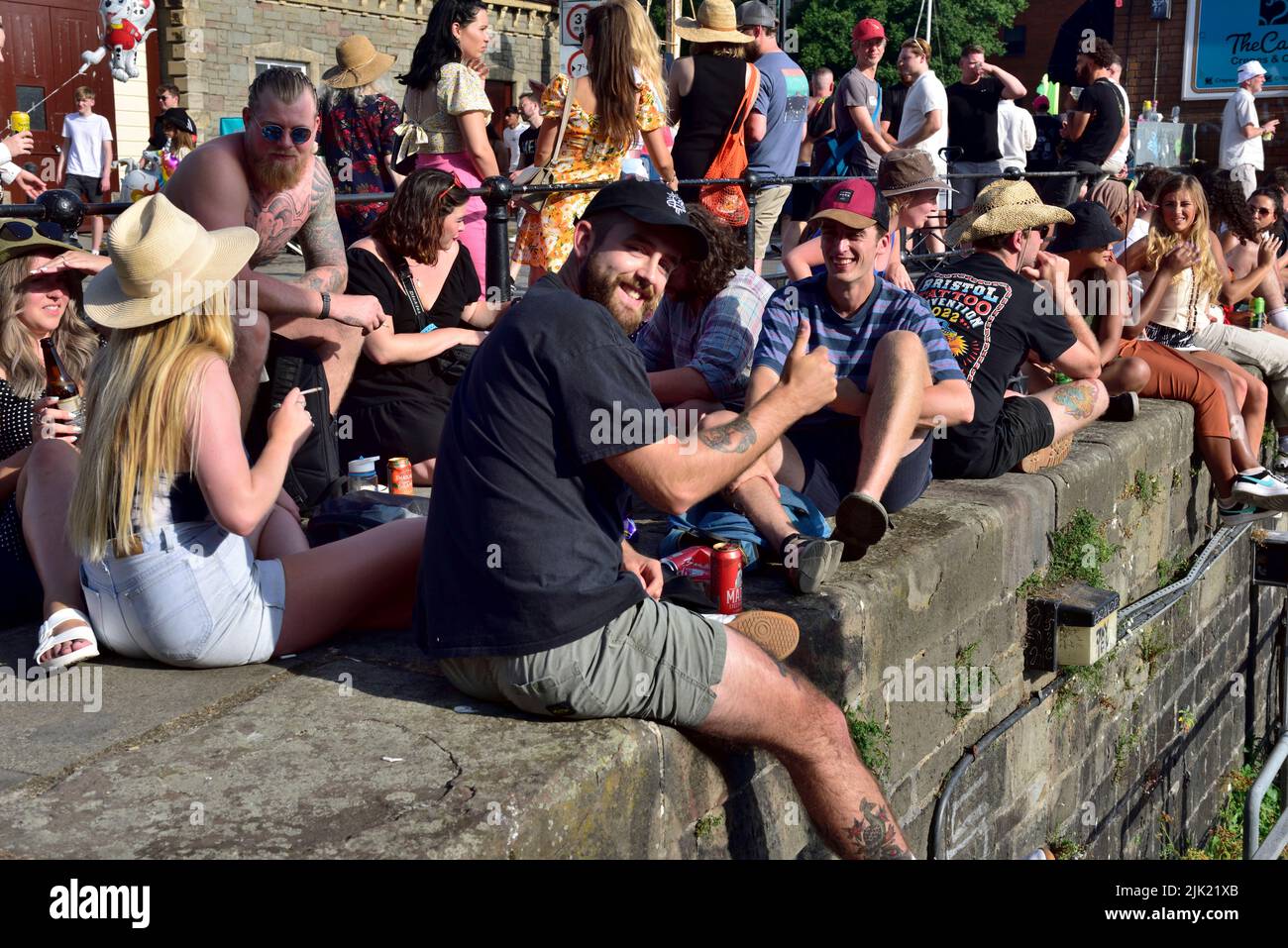 Crowds of people along harbour quayside relaxing on hot summer day, Bristol, UK Stock Photo
