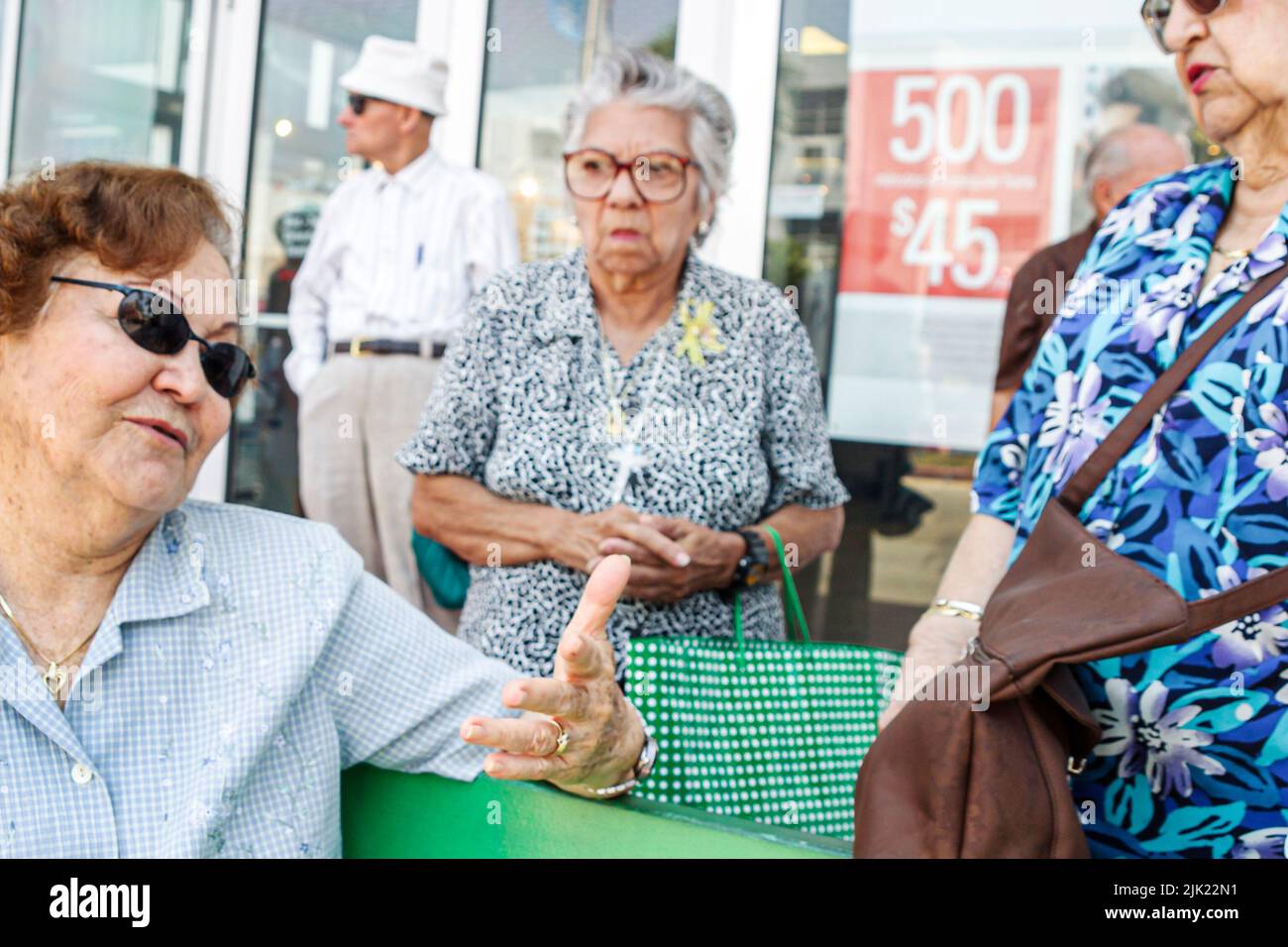 Miami Beach Florida,Hispanic Latin Latino,women seniors residents waiting for public bus stop,riders passengers group people Stock Photo