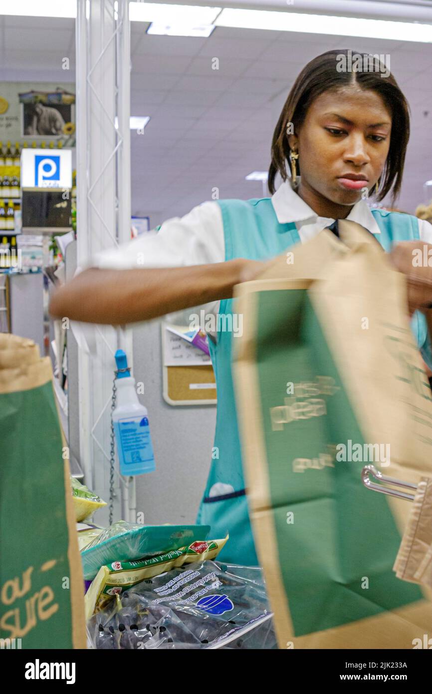 Miami Beach Florida,Publix Grocery Store groceries supermarket inside shopping shopper  Black Blacks woman female bagger worker checkout working Stock Photo