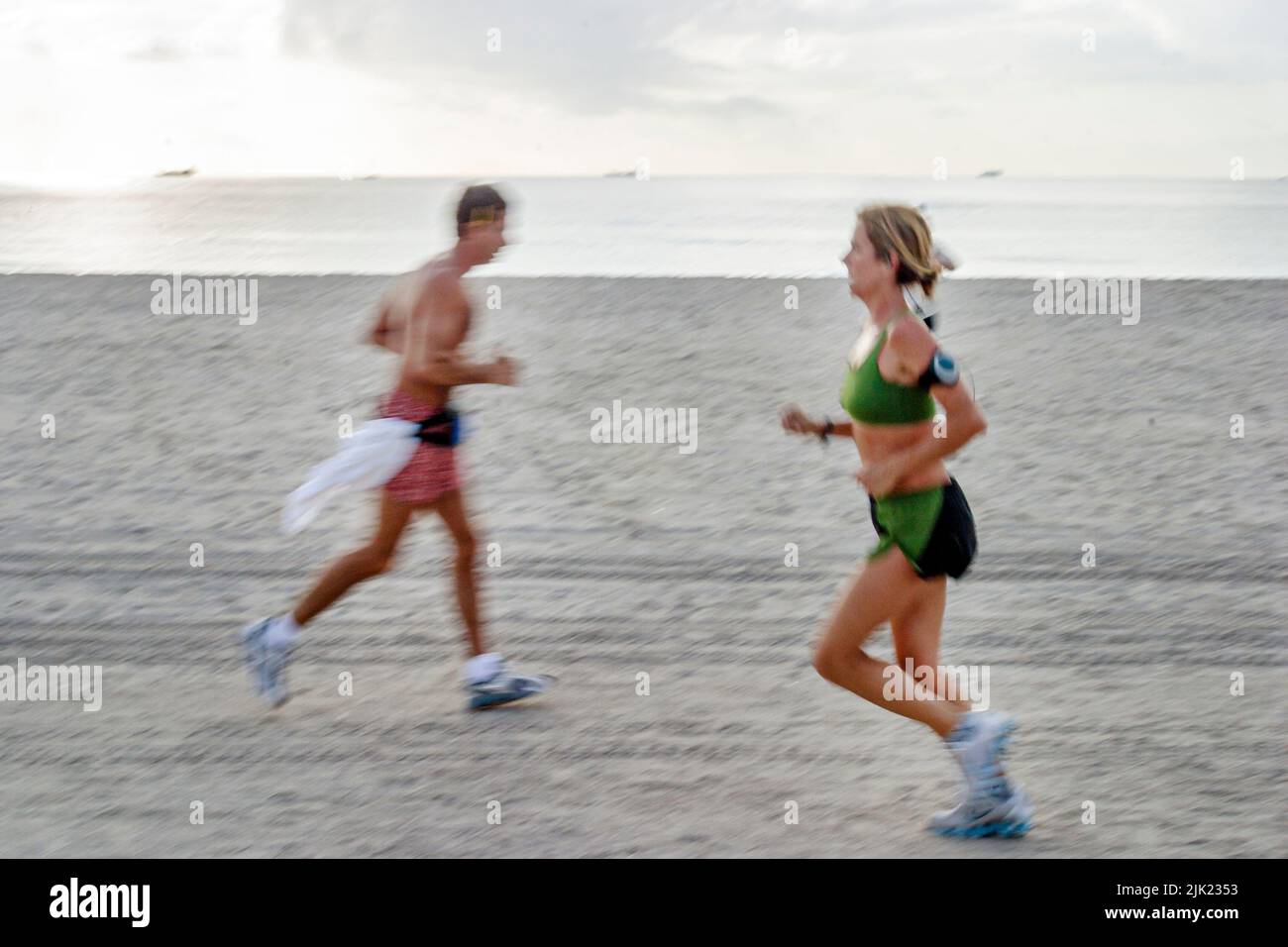 Miami Beach Florida,Atlantic Ocean Shore shoreline coast coastline seashore,adult adults man men male woman female joggers jogging runners running Stock Photo