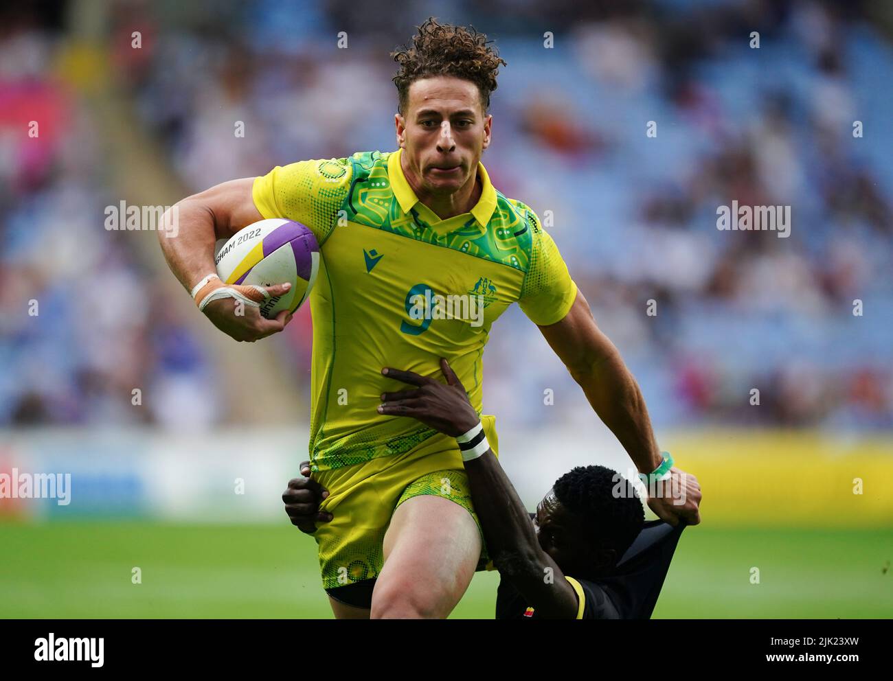 Uganda's Desire Ayera tackles Australia's Mark Nawaqanitawase at