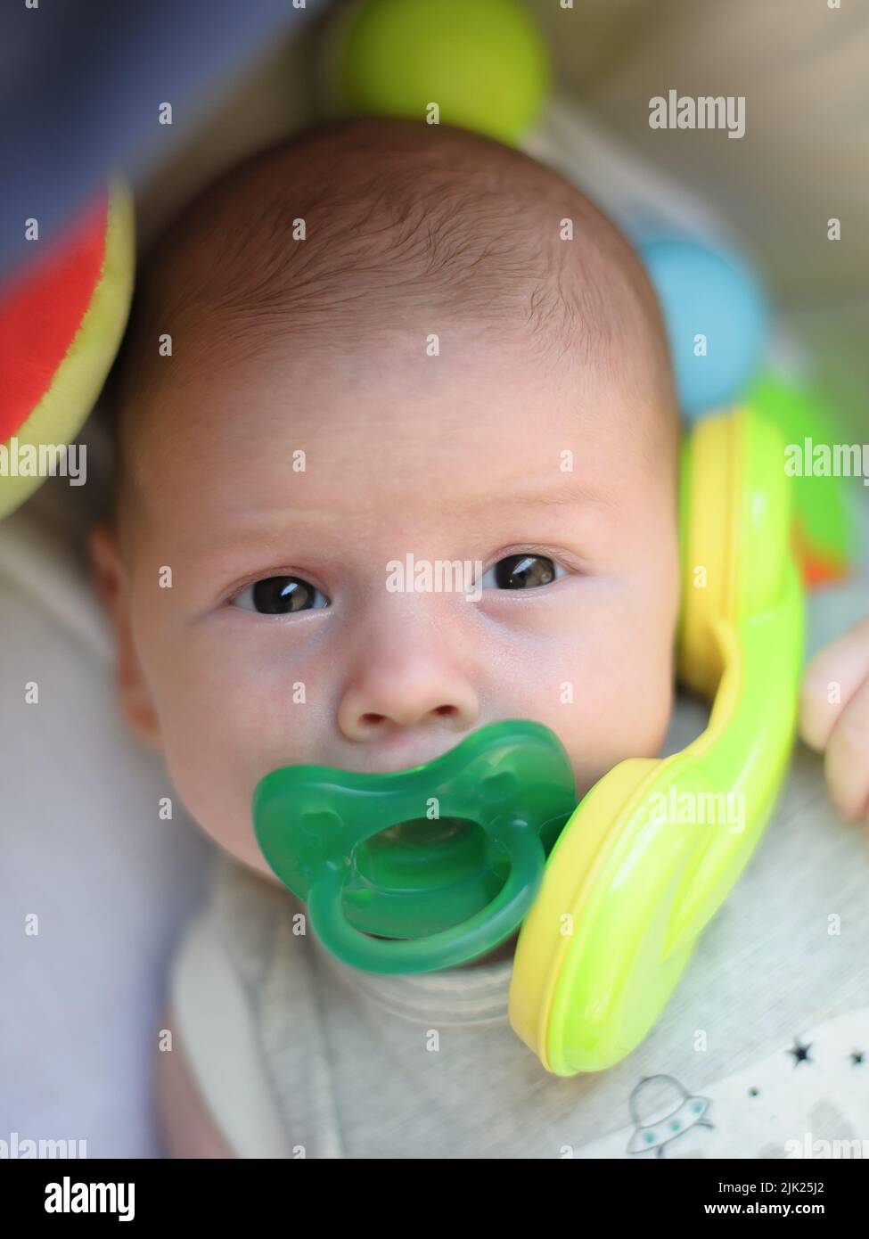 Funny baby boy is talking and using the toy telephone headset in