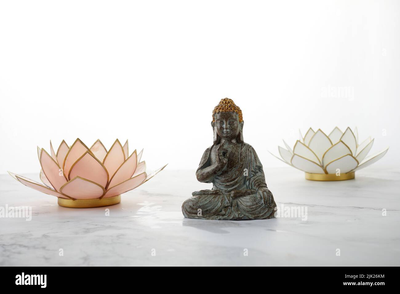 Buddha statue with water lotus on marble background Stock Photo