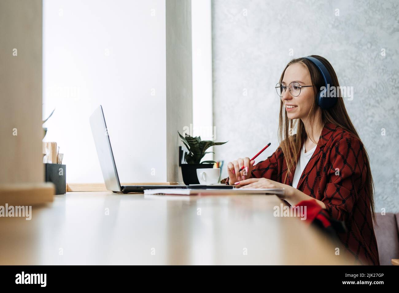 Outsourcing IT Projects, remote work, young professionals. female young programmer, developer working Stock Photo