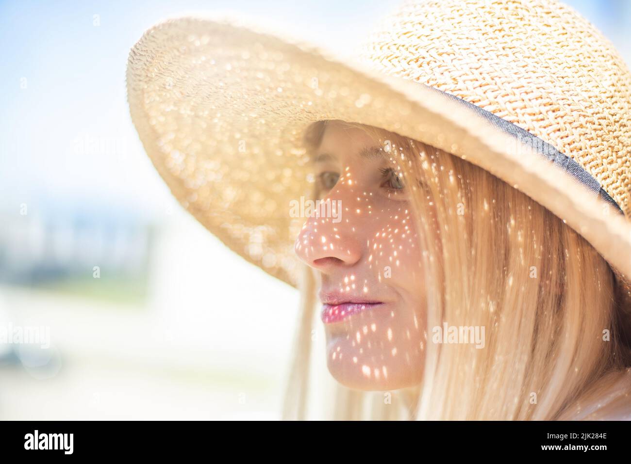Beautiful blond woman in a straw hat Stock Photo - Alamy