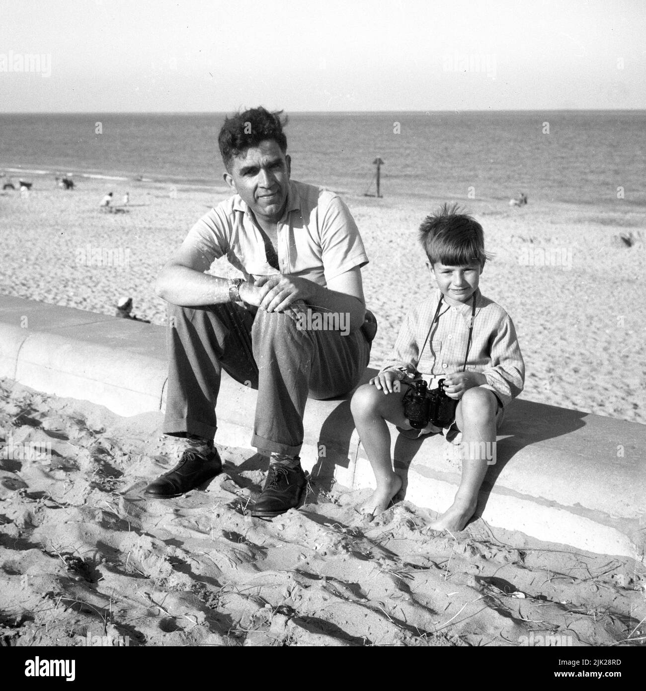 A father and son on holiday at Caister-on-sea in the 1950s Stock Photo ...